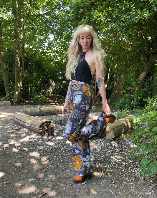 Bohemian 70s retro flare trousers made from a dark grey cotton and bright floral embroidery hand waisted style with back pockets available in various sizes.
