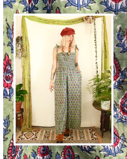 Bohemian hippie style cotton dungaree wide leg jumpsuit, side pockets, in an Indian green and pink funky pattern, adjustable straps with elasticated bust, available in small, medium and large. 